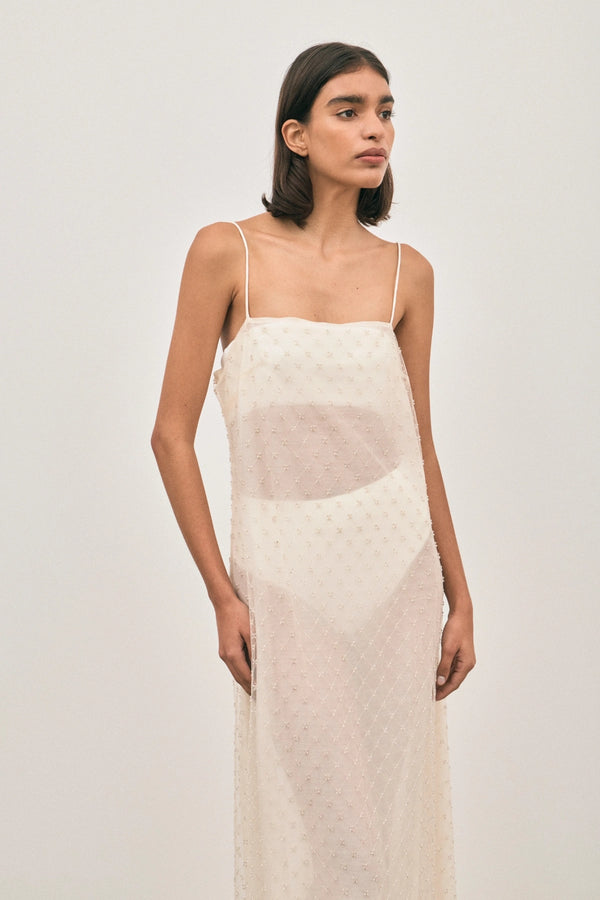 The Camilla Dress Beaded Ivory by Solaqua – sheer beaded maxi dress with geometric embellishments and elegant drape.