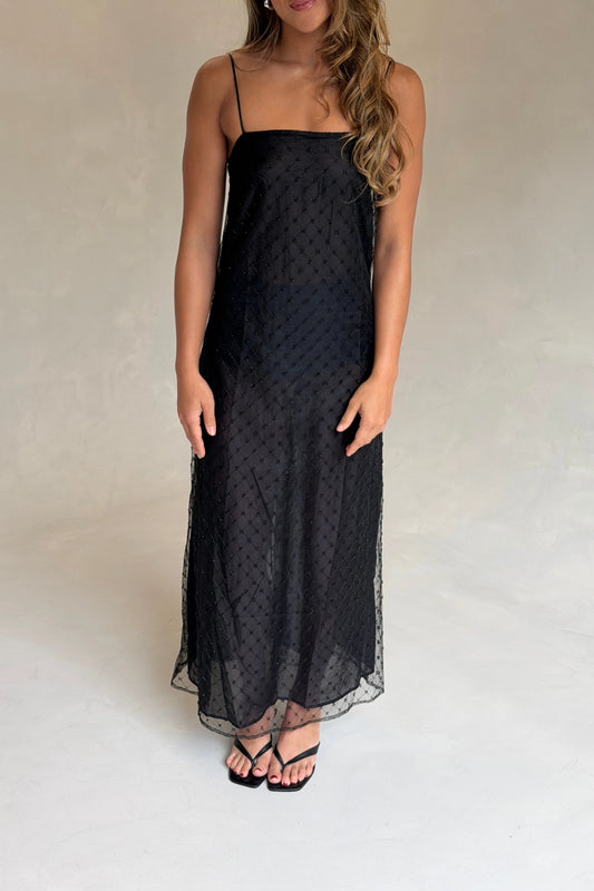 The Camilla Dress Beaded Noir by Solaqua – sheer beaded maxi dress with geometric embellishments and elegant drape.