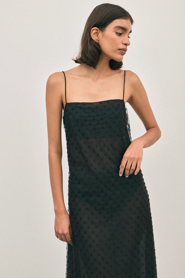 The Camilla Dress Beaded Noir by Solaqua – sheer beaded maxi dress with geometric embellishments and elegant drape.