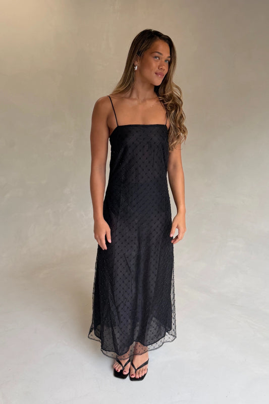 The Camilla Dress Beaded Noir by Solaqua – sheer beaded maxi dress with geometric embellishments and elegant drape.