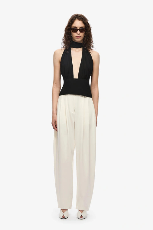 The Capezza Silk Top by MISHA, a plunging halter top with open back and wrap silk bodice. Perfect for sleek day-to-night styling.