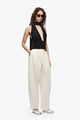 The Capezza Silk Top by MISHA, a plunging halter top with open back and wrap silk bodice. Perfect for sleek day-to-night styling.