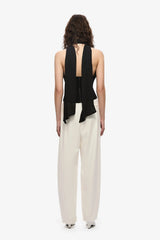 The Capezza Silk Top by MISHA, a plunging halter top with open back and wrap silk bodice. Perfect for sleek day-to-night styling.
