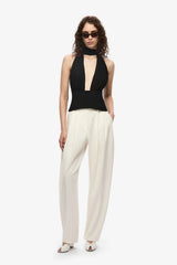 The Capezza Silk Top by MISHA, a plunging halter top with open back and wrap silk bodice. Perfect for sleek day-to-night styling.
