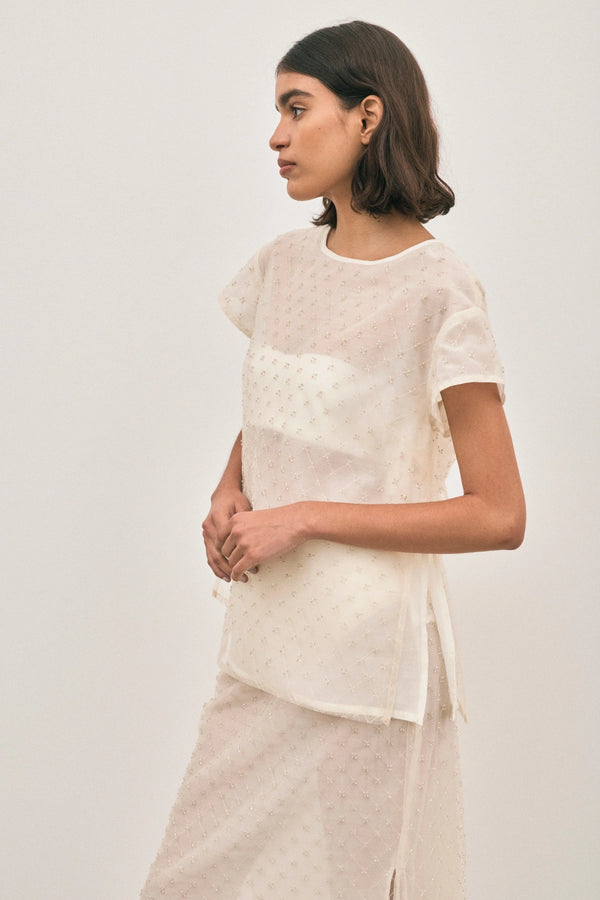 The Chelsea Beaded Top Ivory by Solaqua – sheer beaded top with geometric embellishments and detachable camisole.