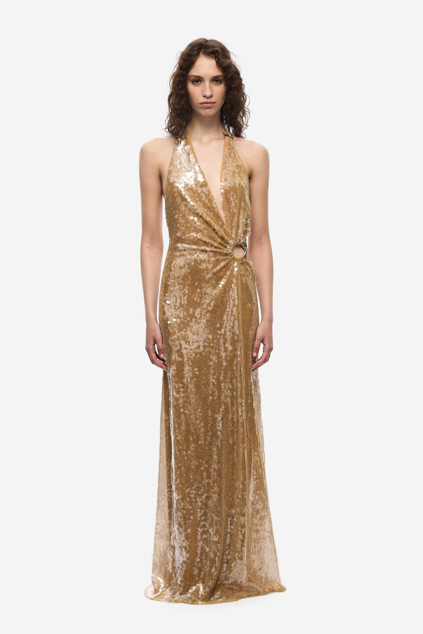 The Devon Sequin Dress by Misha, a mustard gold halter gown with cut-outs and ring detail. Perfect for parties, red carpets, or weddings.