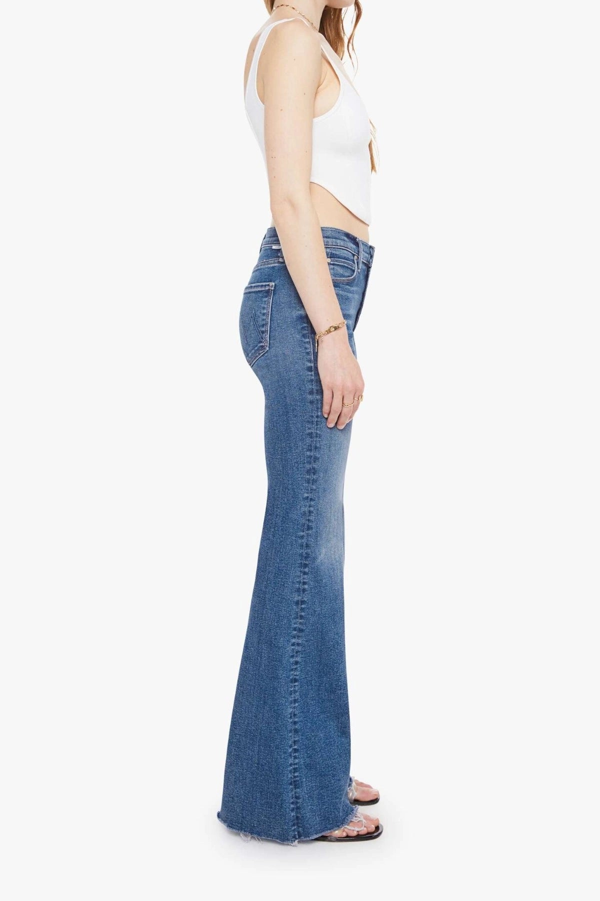 The Doozy Sneaky Fray Let’s Split by MOTHER, high-rise flared jeans with frayed hems and soft fading for an effortless vintage look.