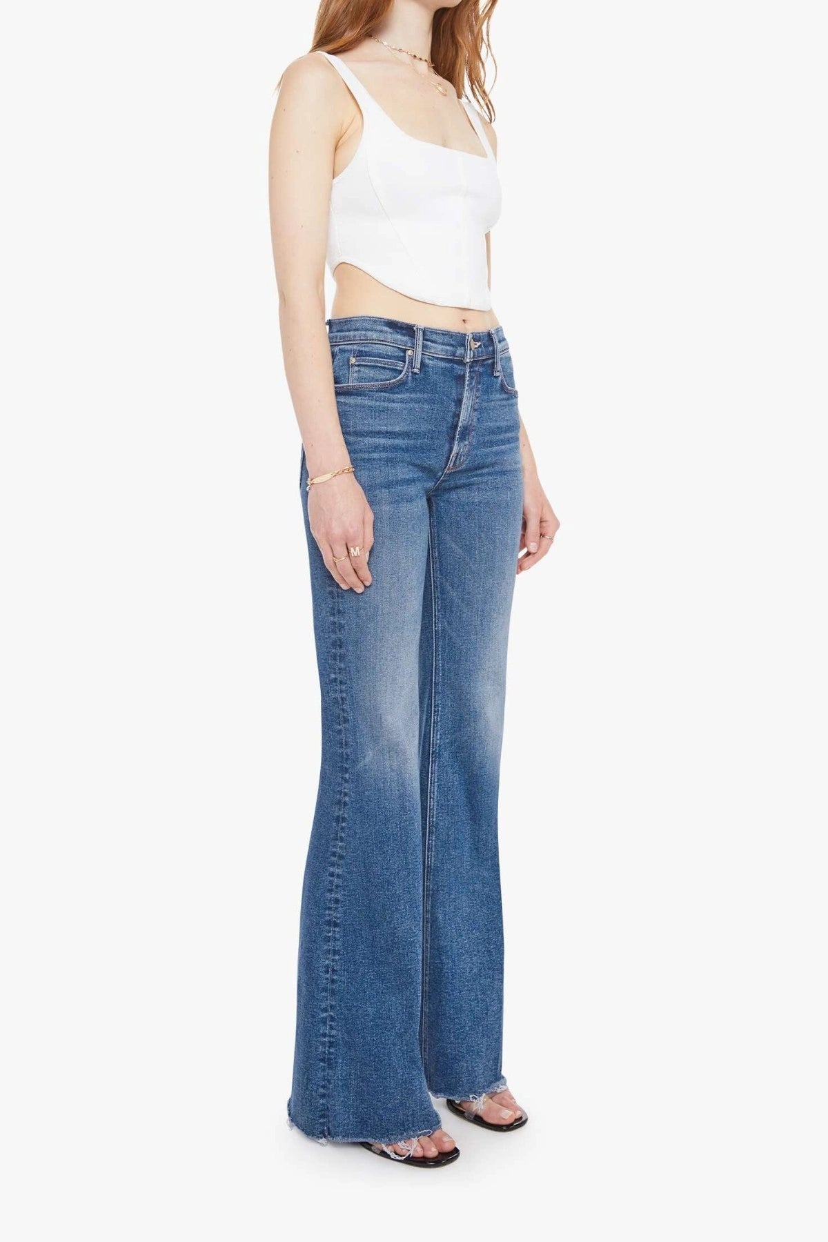 The Doozy Sneaky Fray Let’s Split by MOTHER, high-rise flared jeans with frayed hems and soft fading for an effortless vintage look.