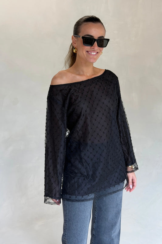 The Eloise Beaded Mini Noir by Solaqua – sheer beaded mini dress with off shoulder neckline and oversized fit.