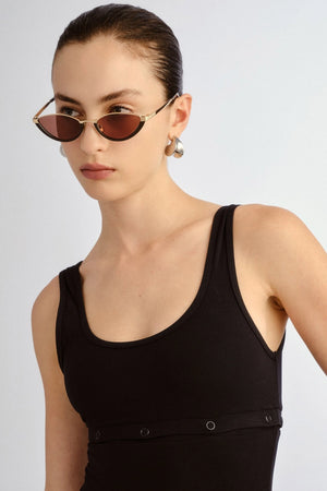 The Lia sunglasses by Luv Lou, black cat-eye frame with metal accents and debossed Organic L pattern, featuring smoke mono lenses.