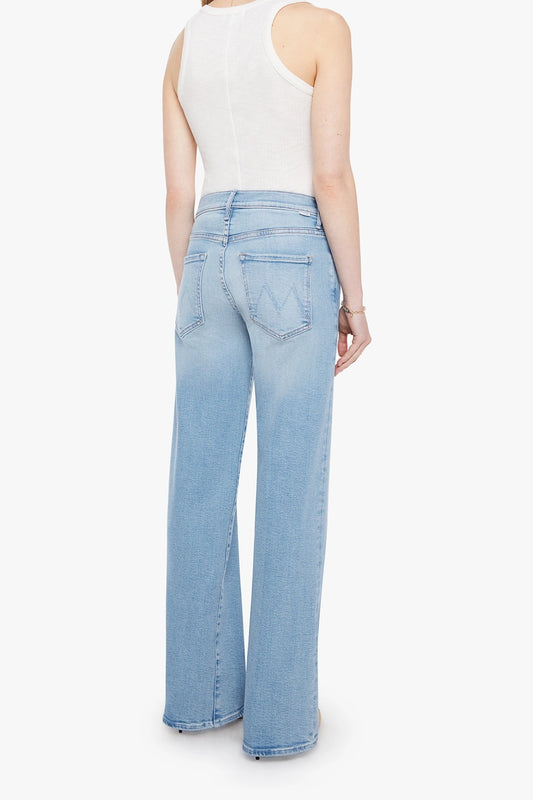 The Mid Rise Maven Sneak Jeans in Blowing In The Wind by MOTHER, wide-leg silhouette with rose gold hardware and contrast stitching. Perfect for elevated casual styling.

