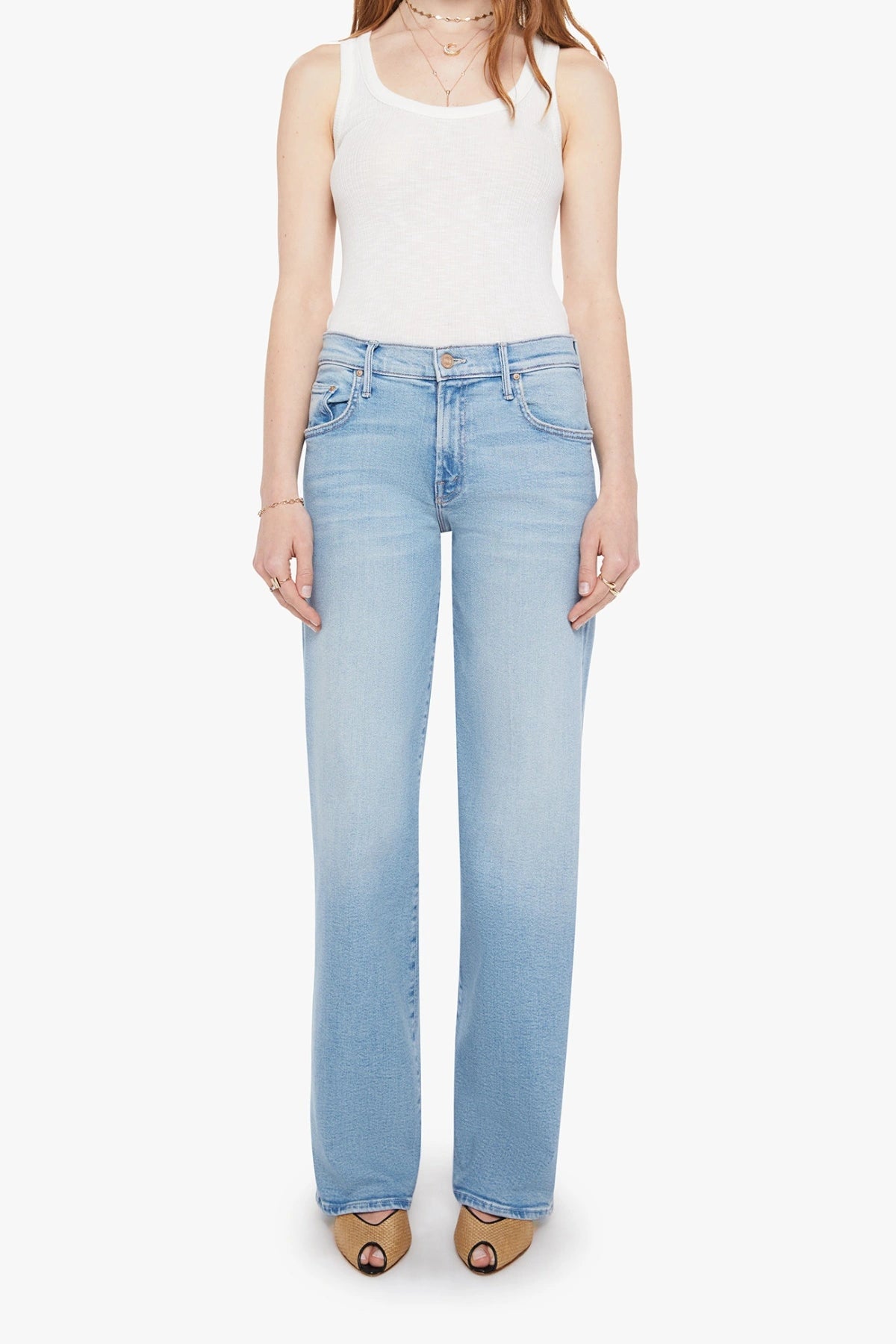 The Mid Rise Maven Sneak Jeans in Blowing In The Wind by MOTHER, wide-leg silhouette with rose gold hardware and contrast stitching. Perfect for elevated casual styling.
