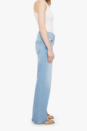 The Mid Rise Maven Sneak Jeans in Blowing In The Wind by MOTHER, wide-leg silhouette with rose gold hardware and contrast stitching. Perfect for elevated casual styling.
