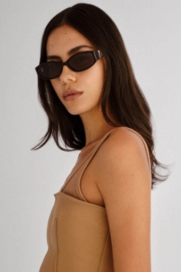 Lottie in Black by Luv Lou, luxe rectangle sunglasses with sculpted angles, gold hardware, and smoke mono CR39 lenses.