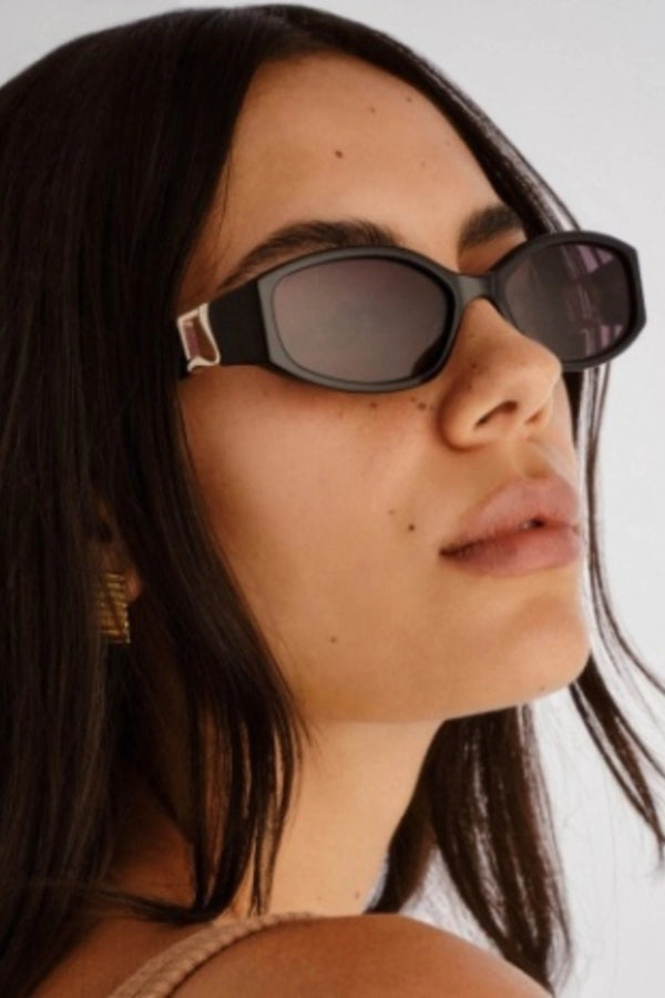 Lottie in Black by Luv Lou, luxe rectangle sunglasses with sculpted angles, gold hardware, and smoke mono CR39 lenses.