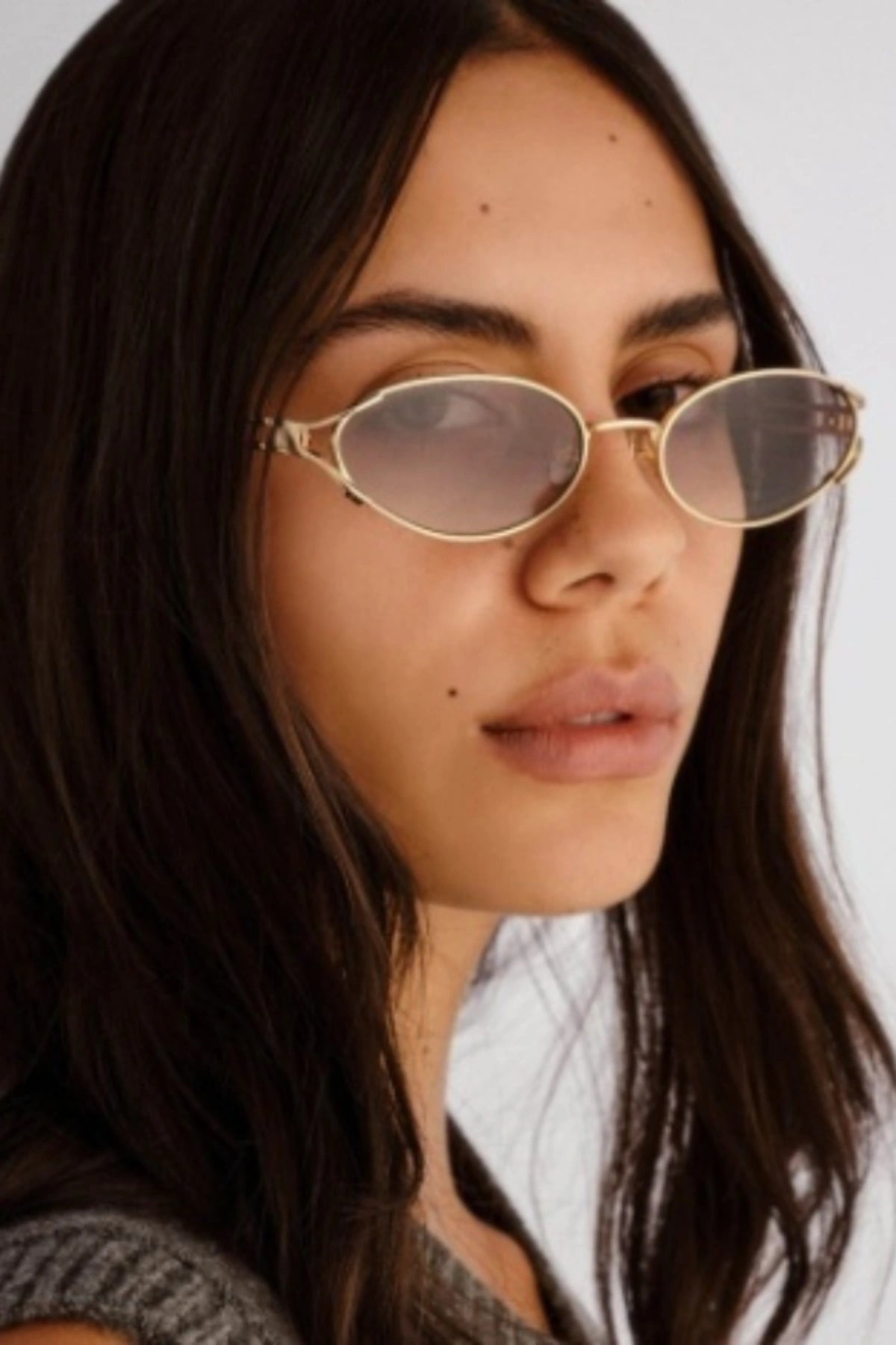 Paloma in Light Gold by Luv Lou, vintage-inspired oval sunglasses with split temples, charcoal gradient CR39 lenses, and debossed hinge.