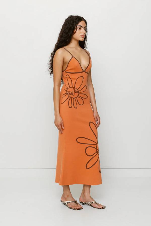 The Wolf Gang Soleil Knit Midi Dress in Jaffa, a form-fitting intarsia knit midi with floral motifs, V-scoop neckline, contrast straps, and low back.