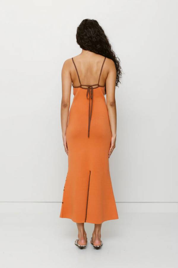The Wolf Gang Soleil Knit Midi Dress in Jaffa, a form-fitting intarsia knit midi with floral motifs, V-scoop neckline, contrast straps, and low back.