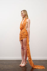 Tiffany Dress in Orange Floral Beaded by DŽO, an embellished mesh mini with cowl neckline, ruched detailing, and asymmetrical train hem.