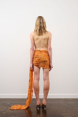 Tiffany Dress in Orange Floral Beaded by DŽO, an embellished mesh mini with cowl neckline, ruched detailing, and asymmetrical train hem.