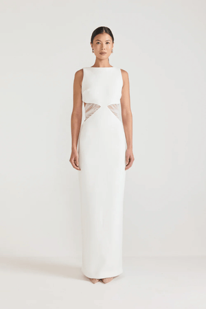 Bellina Dress Black by Tojhà, a sculptural crepe maxi with waist cut-out and mesh tie detail. Perfect for striking modern evening looks.