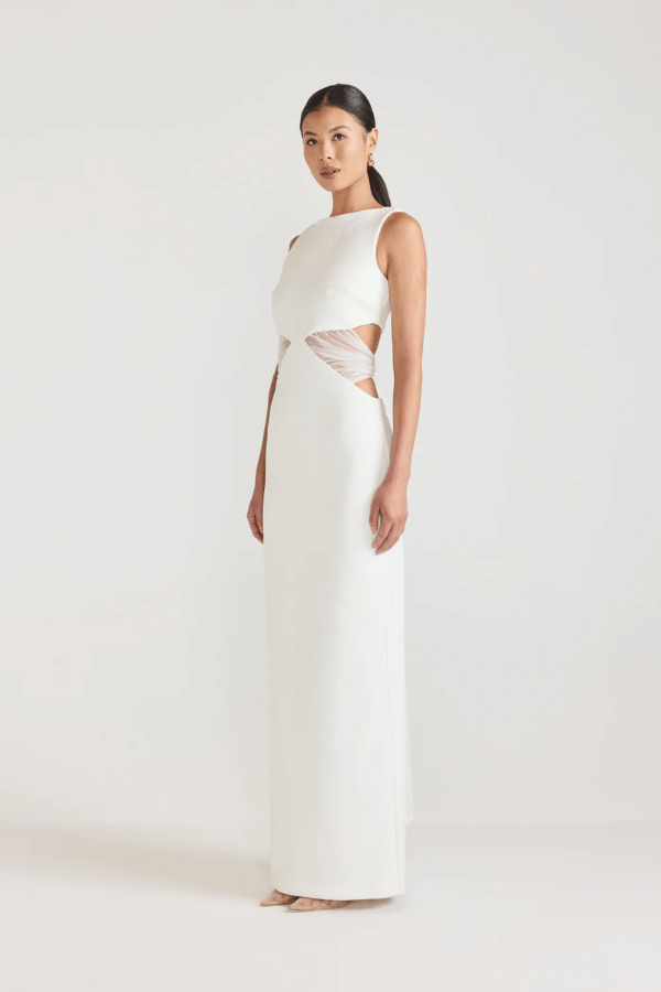 Bellina Dress Black by Tojhà, a sculptural crepe maxi with waist cut-out and mesh tie detail. Perfect for striking modern evening looks.