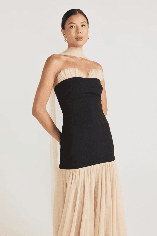 Strapless Maxi Gown Black by Tojhà, a bold crepe silhouette with sheer mesh skirt and ruffle neckline. Perfect for standout formal events.