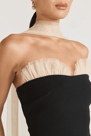 Strapless Maxi Gown Black by Tojhà, a bold crepe silhouette with sheer mesh skirt and ruffle neckline. Perfect for standout formal events.