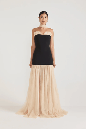 Strapless Maxi Gown Black by Tojhà, a bold crepe silhouette with sheer mesh skirt and ruffle neckline. Perfect for standout formal events.