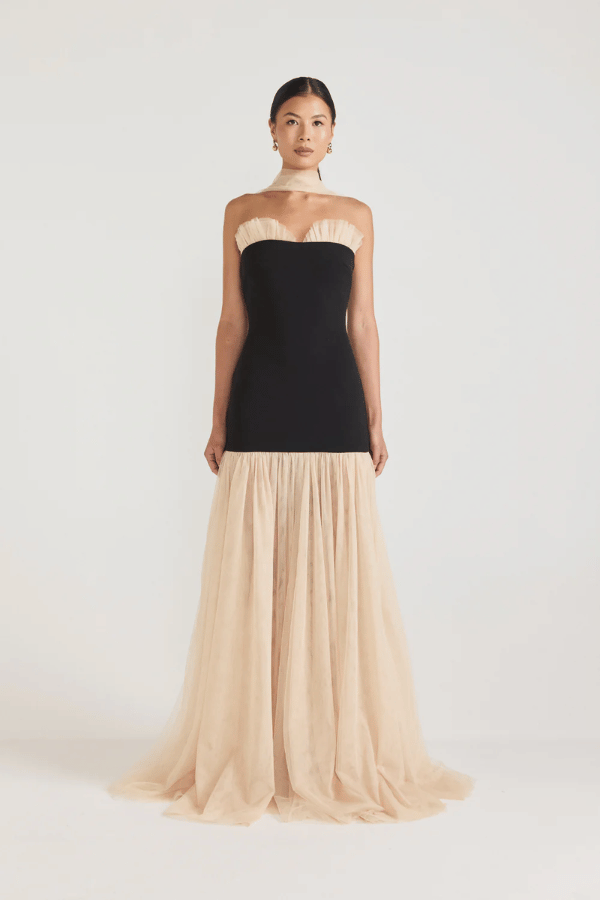 Strapless Maxi Gown Black by Tojhà, a bold crepe silhouette with sheer mesh skirt and ruffle neckline. Perfect for standout formal events.