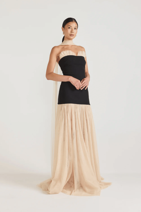 Strapless Maxi Gown Black by Tojhà, a bold crepe silhouette with sheer mesh skirt and ruffle neckline. Perfect for standout formal events.