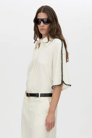 Trevi Shirt by in Cream Camilla and Marc – a cream short-sleeve shirt with hand-sewn bead details and clean tailoring, perfect for polished warm days.