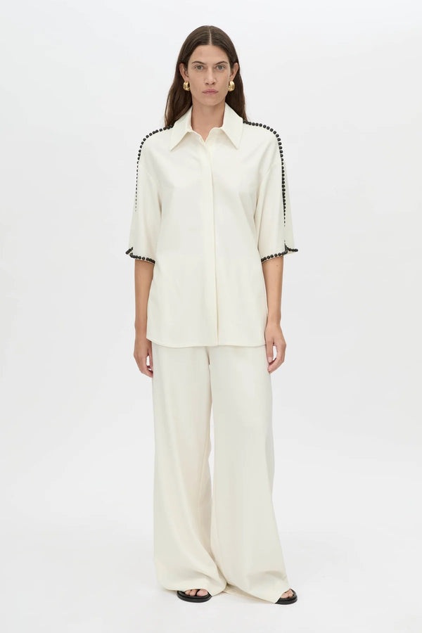 Trevi Shirt by in Cream Camilla and Marc – a cream short-sleeve shirt with hand-sewn bead details and clean tailoring, perfect for polished warm days.
