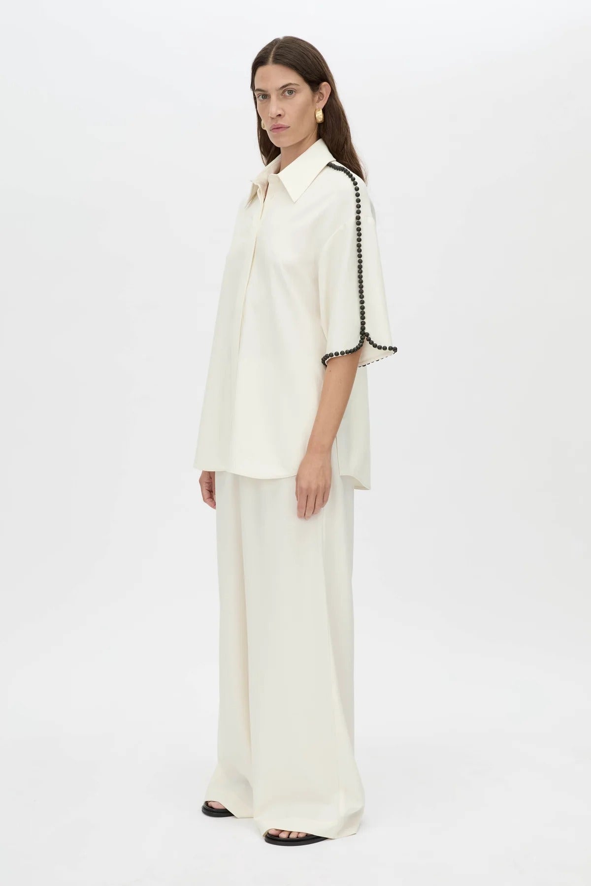 Trevi Shirt by in Cream Camilla and Marc – a cream short-sleeve shirt with hand-sewn bead details and clean tailoring, perfect for polished warm days.
