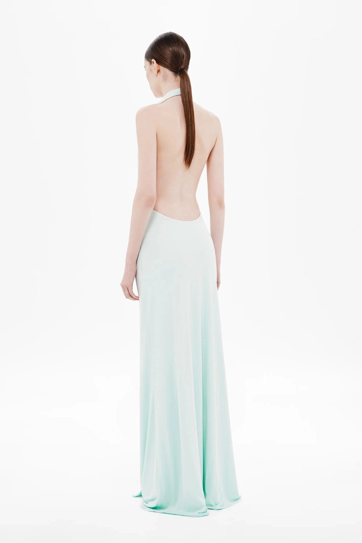 Unity Jersey Dress by Misha, a plunge-neck maxi with soft jersey drape and hardware sash. Perfect for elegant nights and formal occasions.