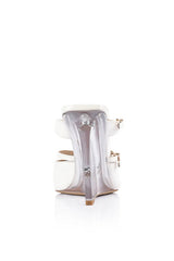 VGwen Wedge in Lucite & White Leather by Lana Wilkinson, a pointed-toe mule with adjustable strap and green lucite wedge heel.
