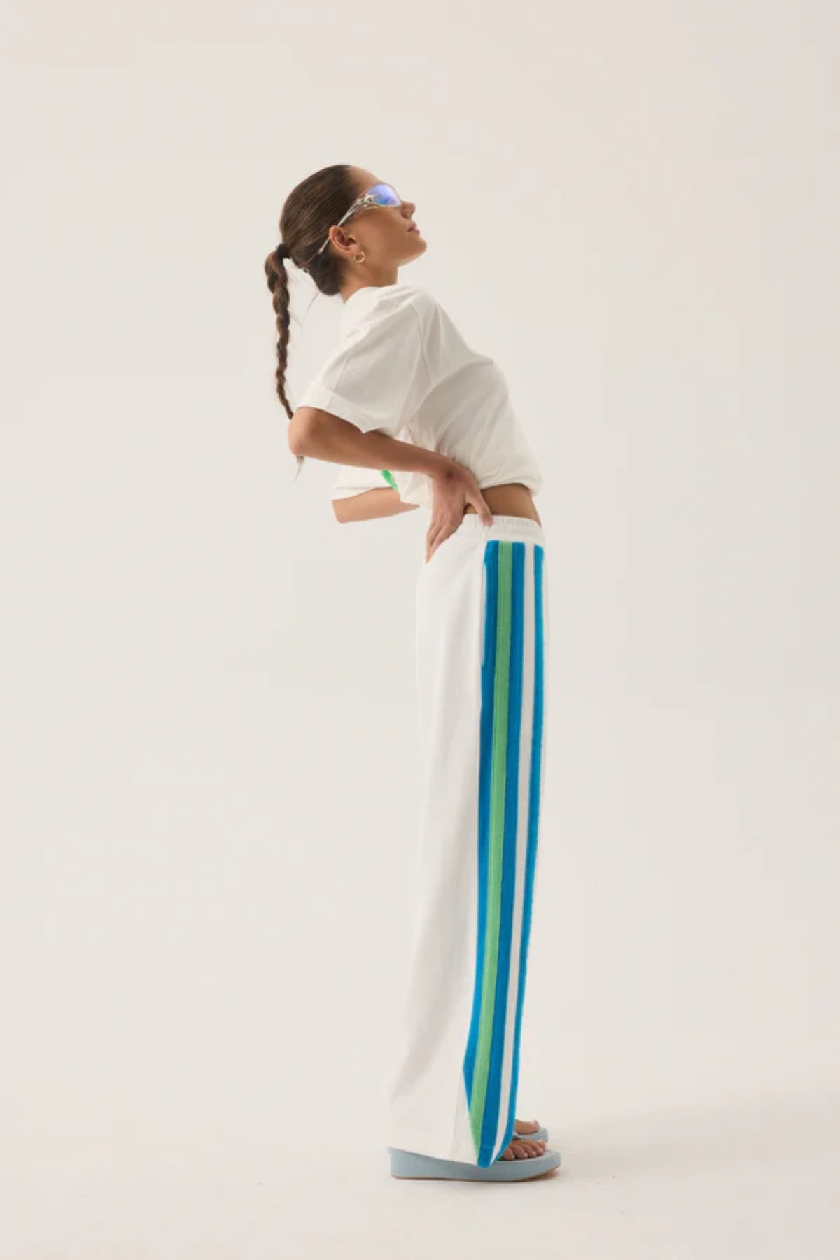 Vacation Sporty Pant by Araminta James — a white wide-leg sports-sheen pant with velour trims and elastic waist, perfect for relaxed styling.