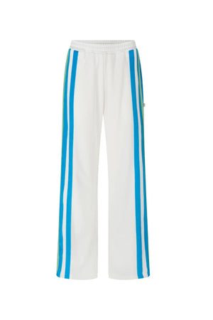 Vacation Sporty Pant by Araminta James — a white wide-leg sports-sheen pant with velour trims and elastic waist, perfect for relaxed styling.