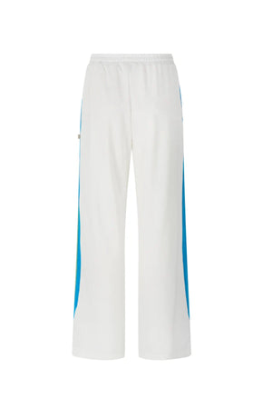 Vacation Sporty Pant by Araminta James — a white wide-leg sports-sheen pant with velour trims and elastic waist, perfect for relaxed styling.