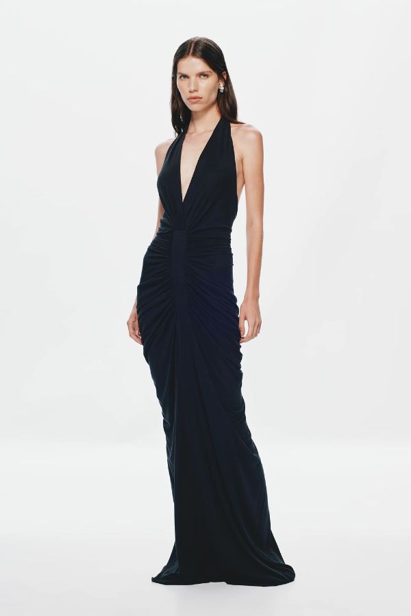 Venus Gathered Cupro Maxi Dress by Misha, a black plunging halter gown with ruched draping and mermaid hem. Perfect for formal events.
 