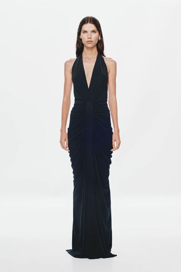 Venus Gathered Cupro Maxi Dress by Misha, a black plunging halter gown with ruched draping and mermaid hem. Perfect for formal events.
