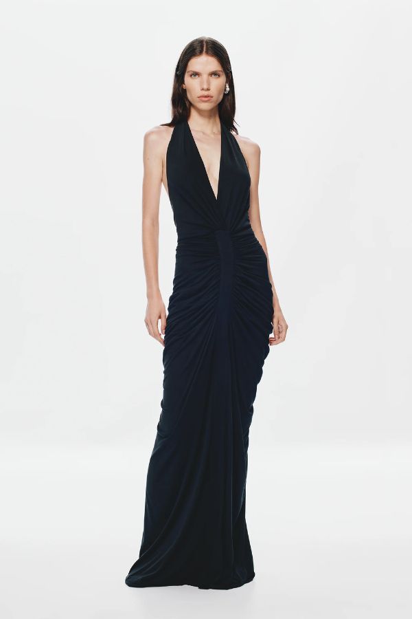 Venus Gathered Cupro Maxi Dress by Misha, a black plunging halter gown with ruched draping and mermaid hem. Perfect for formal events.
