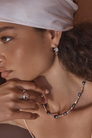 Vesper Ring by Amber Sceats – handcrafted in Italy from 24K gold-plated brass with a curved design and cubic zirconia crystal accent.
 2