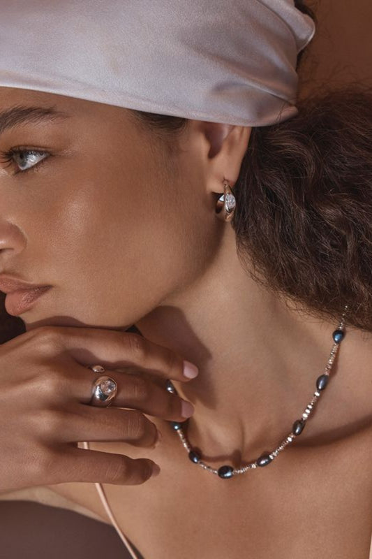 Vesper Ring by Amber Sceats – handcrafted in Italy from 24K gold-plated brass with a curved design and cubic zirconia crystal accent.
 2