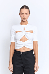 Vicolo Top Powder by Pfeiffer – a fitted tee with cutout detail and hardware. Perfect for edgy everyday styling.