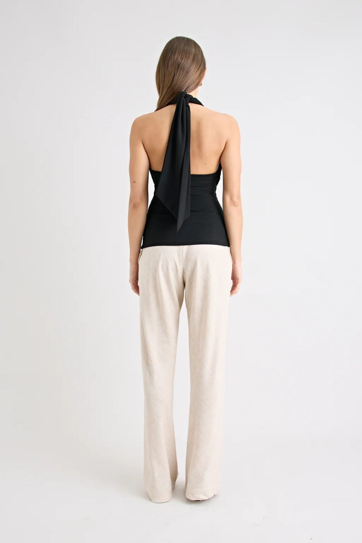 Victoria Top Black by Pfeiffer, sculpting wrap-style jersey top with double lining and adjustable ties for a sleek, curve-enhancing fit.