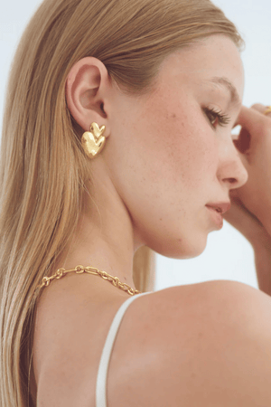 Vivienne Earrings in Gold by Avant Studio, gold heart earrings with retro design. Perfect for statement styling or everyday wear.
