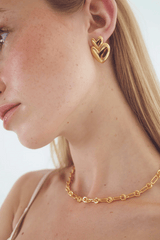 Vivienne Earrings in Gold by Avant Studio, gold heart earrings with retro design. Perfect for statement styling or everyday wear.