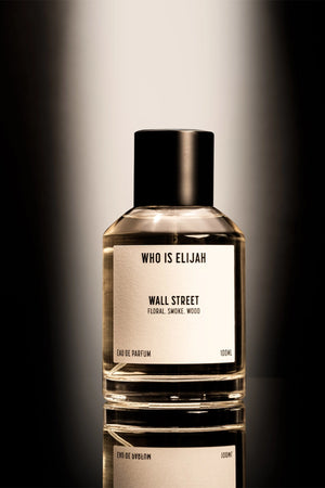 Wall Street by Who Is Elijah, a smoky, woody floral fragrance with rose, raspberry, Egyptian geranium, oud, incense, saffron, amberwood, and leather.