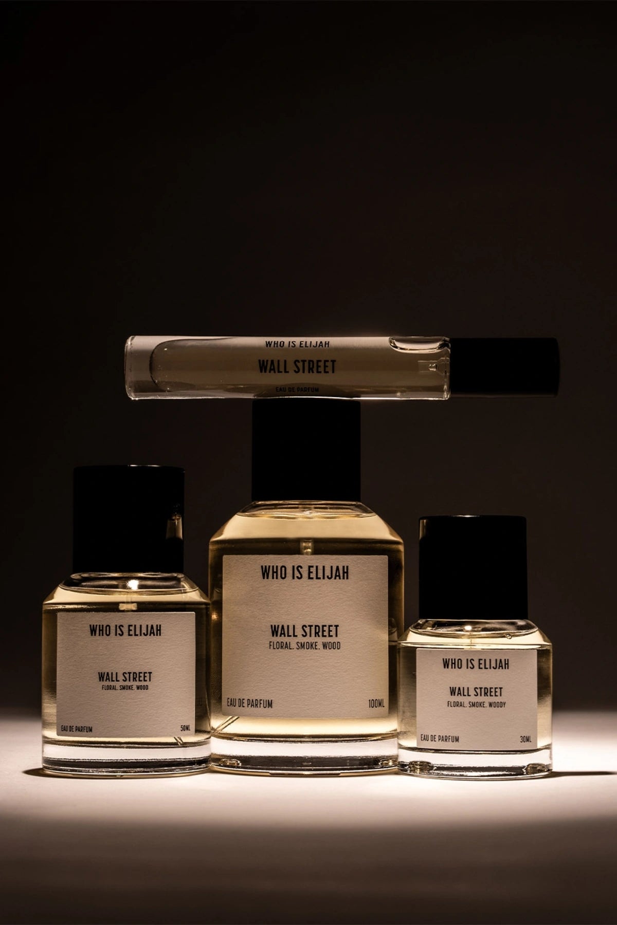 Wall Street by Who Is Elijah, a smoky, woody floral fragrance with rose, raspberry, Egyptian geranium, oud, incense, saffron, amberwood, and leather.